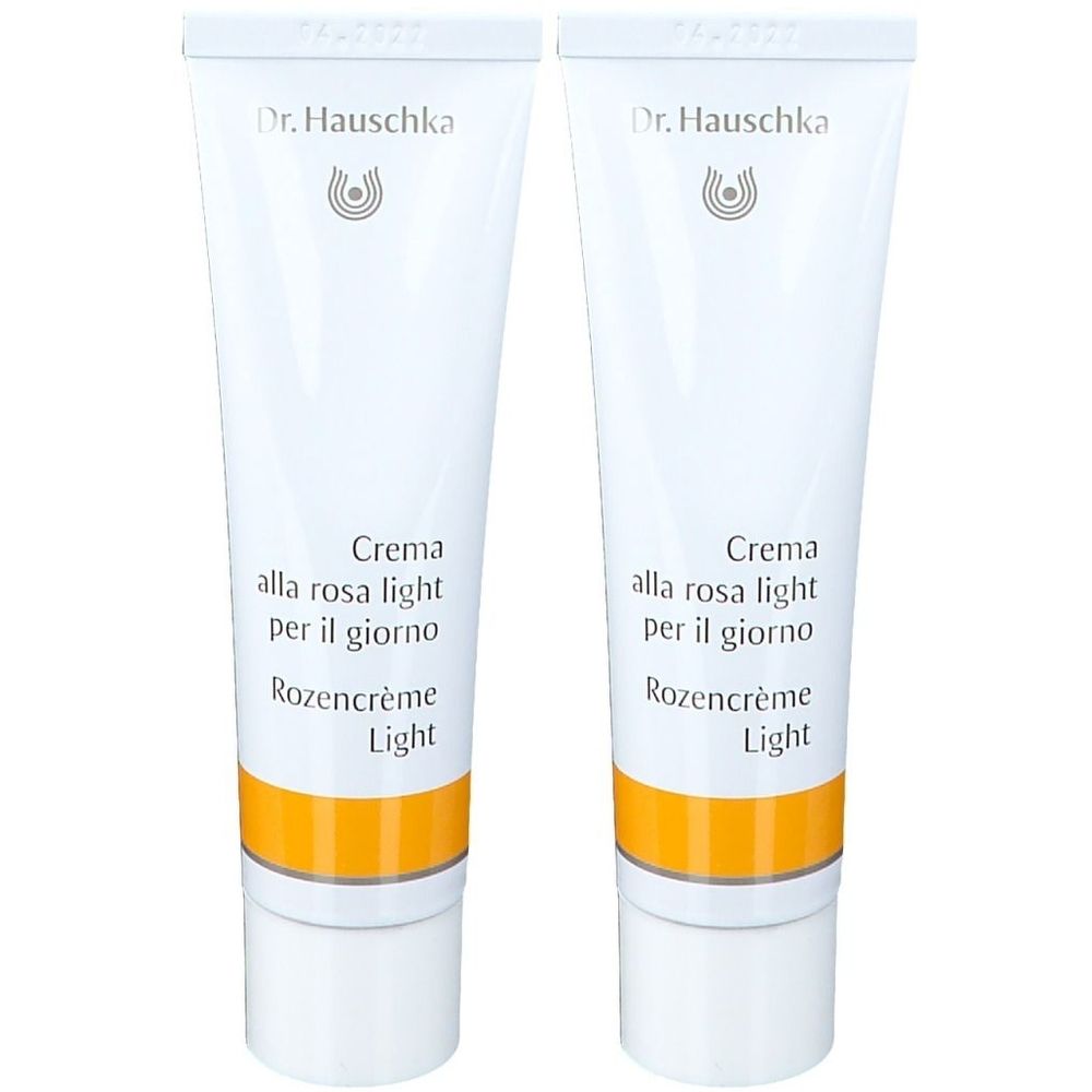 Deux tubes de crème. Blanc, avec une bande jaune et du texte. Marque : Dr. Hauschka. Texte : Crème de Jour Légère à la Rose.