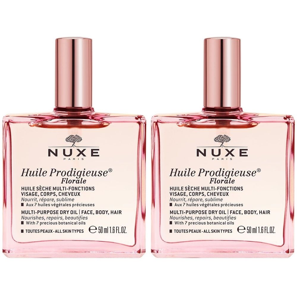 Deux flacons carrés avec liquide rose et bouchons roses. Inscription : Nuxe Huile Prodigieuse Florale. Huile sèche multifonctions visage, corps, cheveux.
