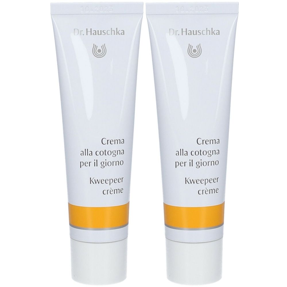 Deux tubes de crème. Tubes blancs avec bande jaune et texte. Marque: Dr. Hauschka. Texte: Crema alla cotogna per il giorno, Kweepeer crème.