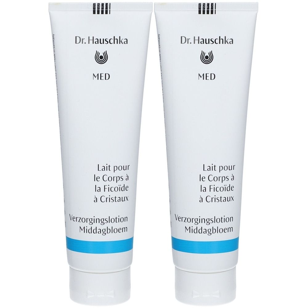 Deux tubes blancs avec texte bleu. Inscription: Dr. Hauschka MED, Lait pour le Corps à la Ficoïde à Cristaux.