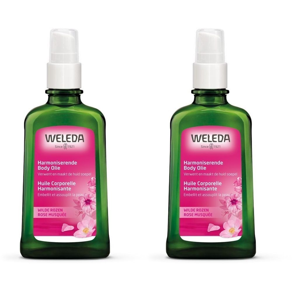 Deux flacons verts avec vaporisateur. L'étiquette porte les inscriptions "WELEDA", "Harmoniserende Body Olie" et "Huile Corporelle Harmonisante".
