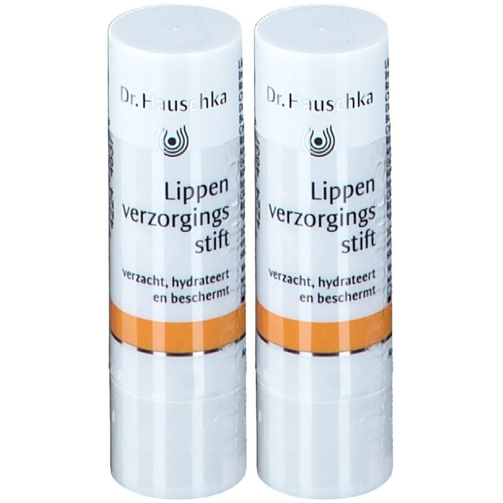 Deux sticks à lèvres blancs avec une bande orange. Inscription : Dr. Hauschka, Lippen verzorgings stift.