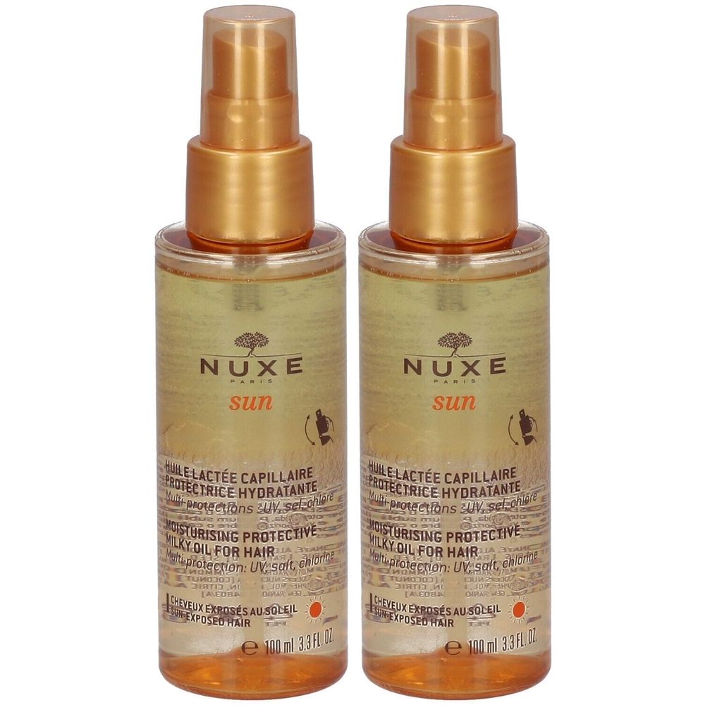 Deux flacons de Nuxe Sun Huile Lactée Capillaire. Têtes de pulvérisation dorées, flacons transparents avec liquide jaune. Texte: Nuxe Sun, Huile Lactée Capillaire.