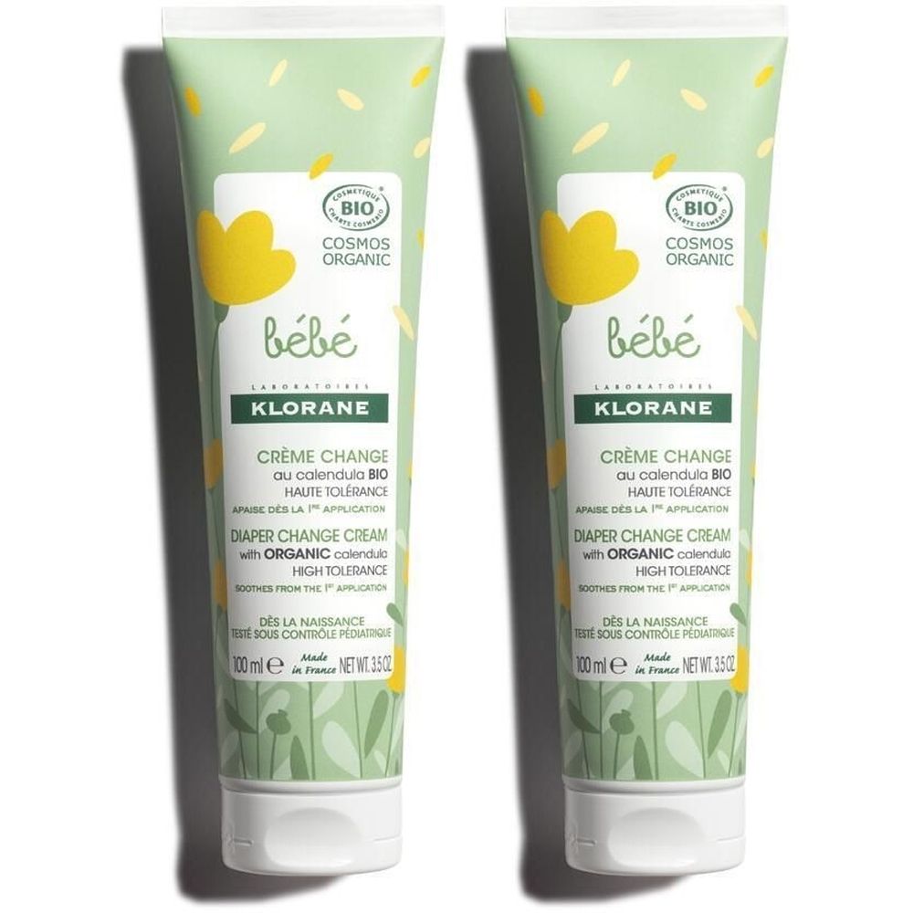 Zwei Tuben Creme für Babys. Grün-weißes Design mit gelben Blumen und Schriftzug. Aufschrift: Crème Change, Haute Tolérance.