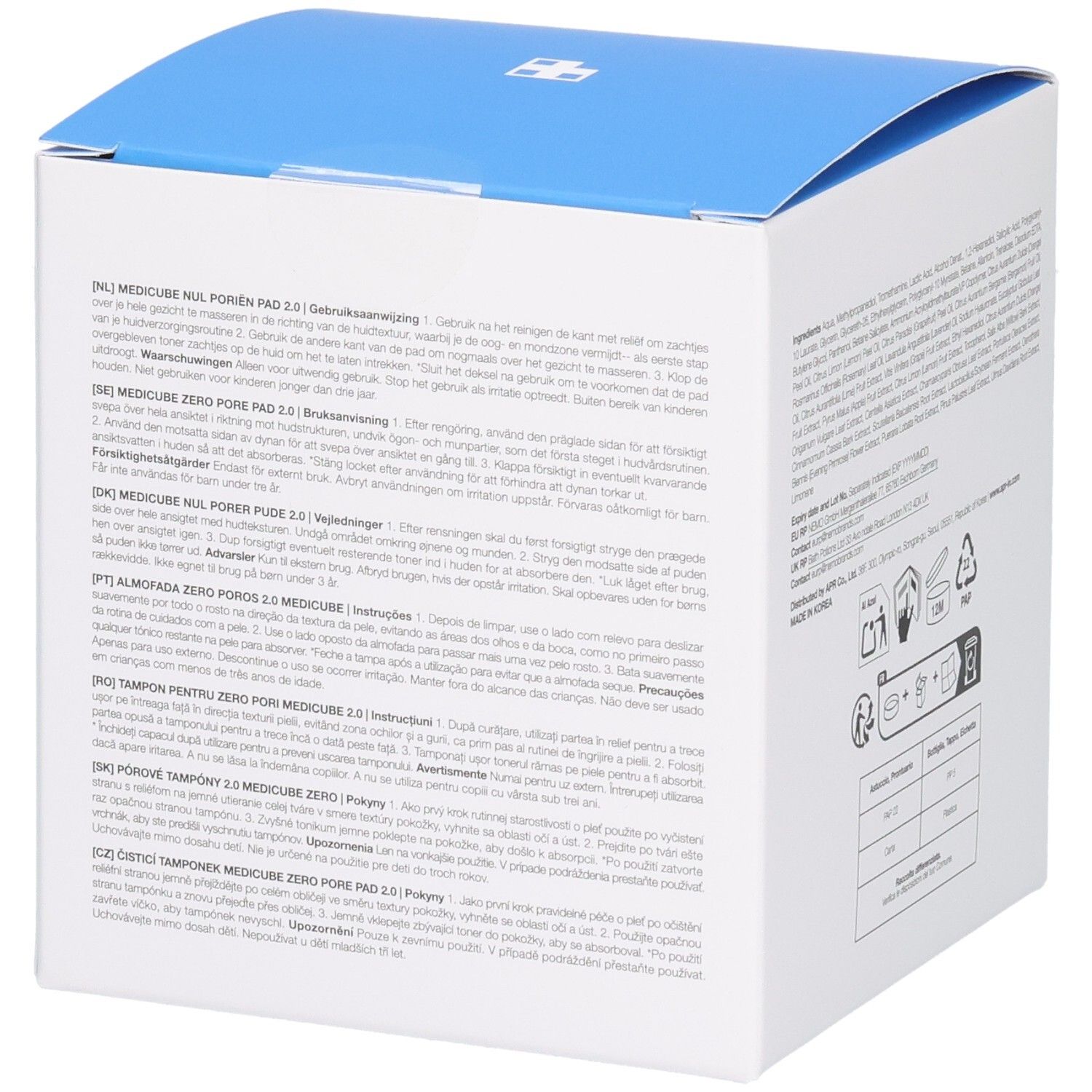 Weiße quadratische Verpackung mit blauem Deckel. Text in mehreren Sprachen, Recycling-Symbole und Gebrauchsanweisungen.