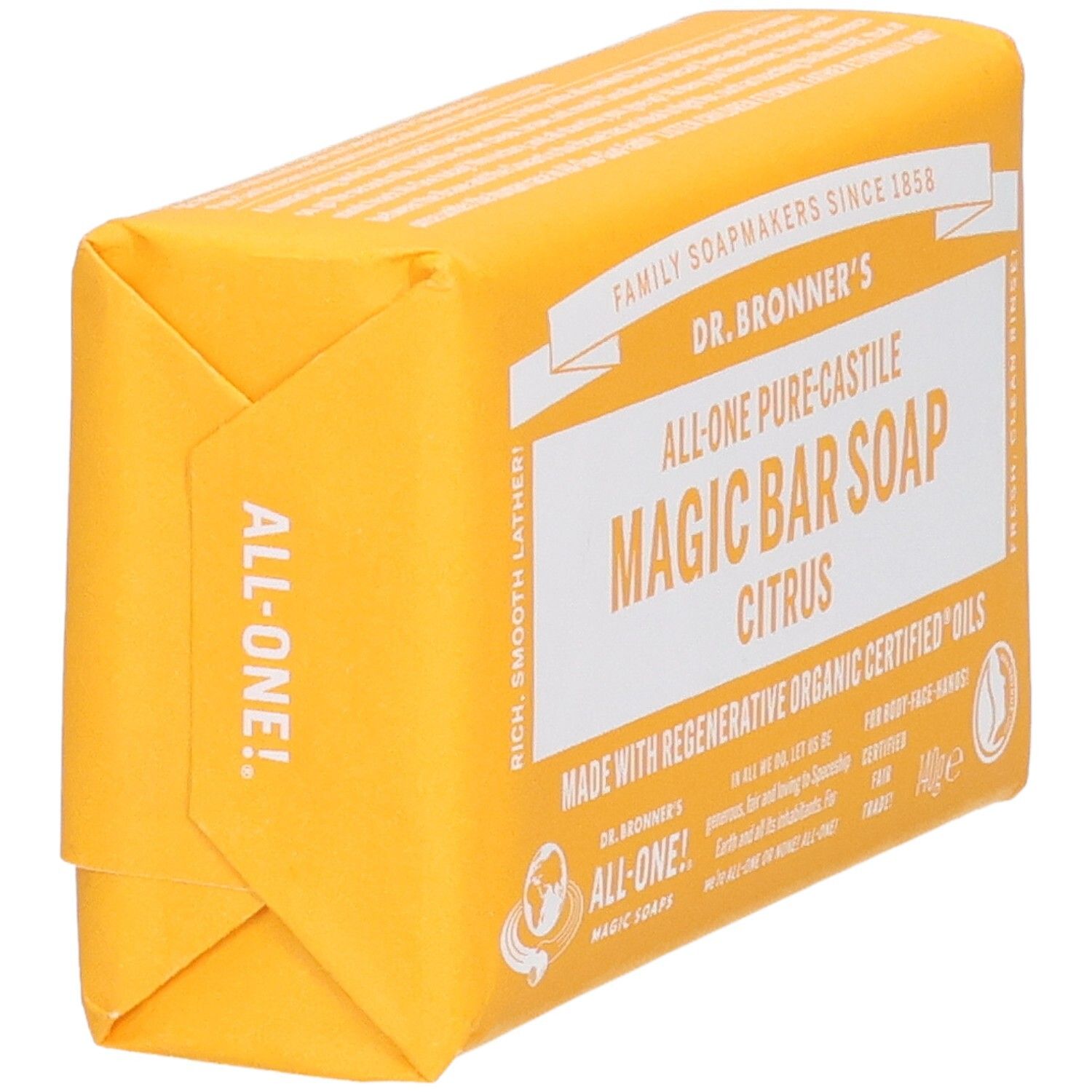 Gelbes Seifenstück in Papierverpackung. Aufschrift: Dr. Bronner's Magic Bar Soap Citrus. Ansicht schräg.