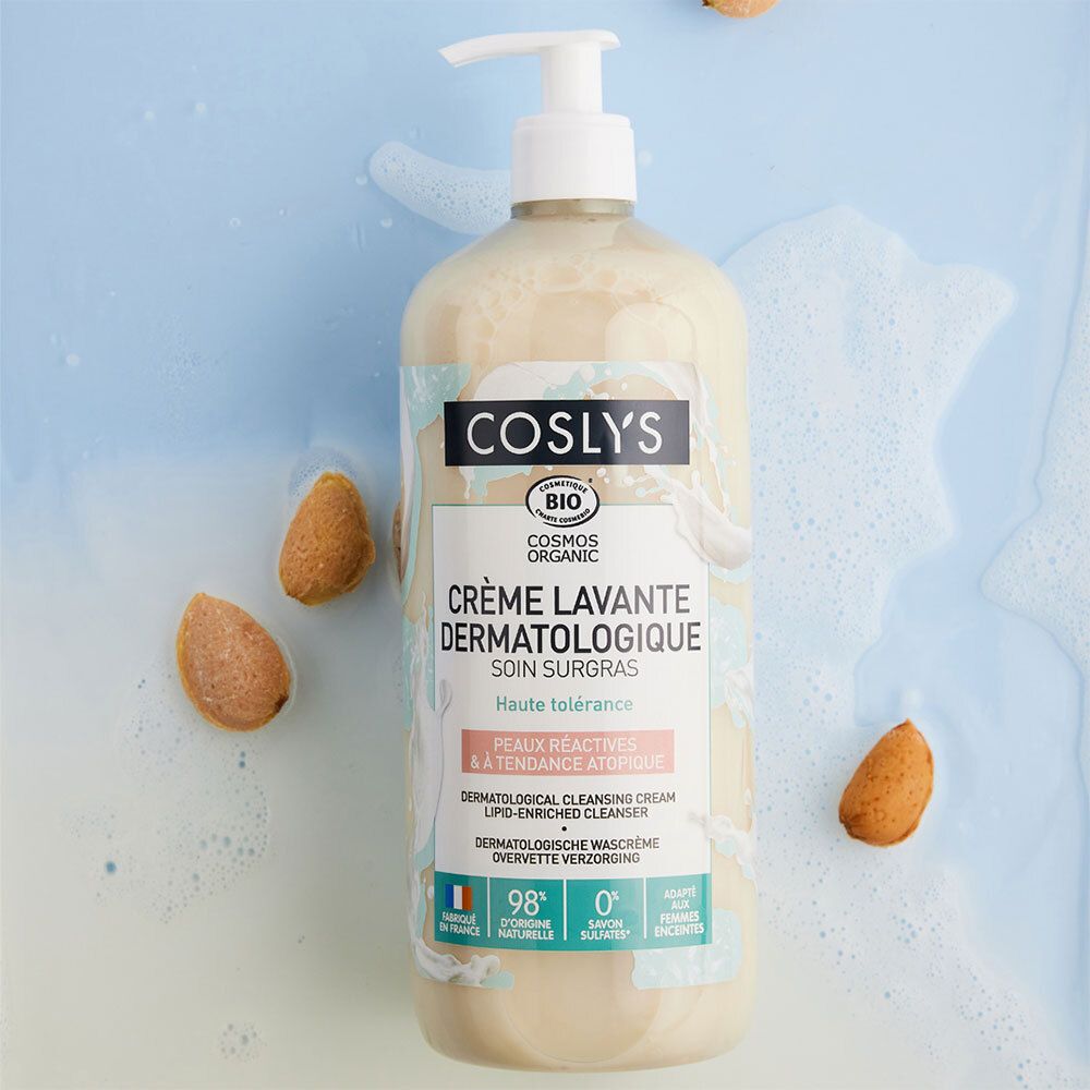 Coslys Creme lavante dermatologique. Flasche mit Spender. Mandeln liegen um die Flasche herum.