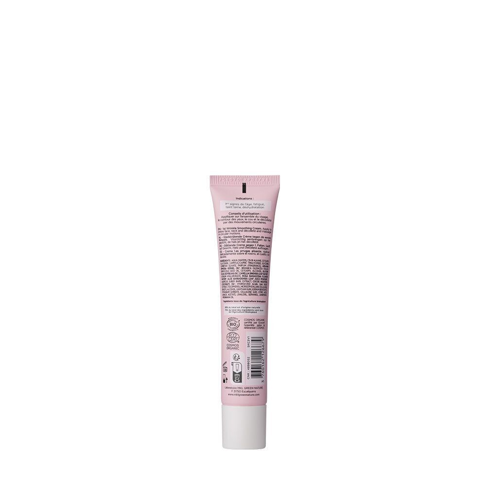 Dos d'un tube de crème rose, bouchon blanc. Texte multilingue. Logos et informations.