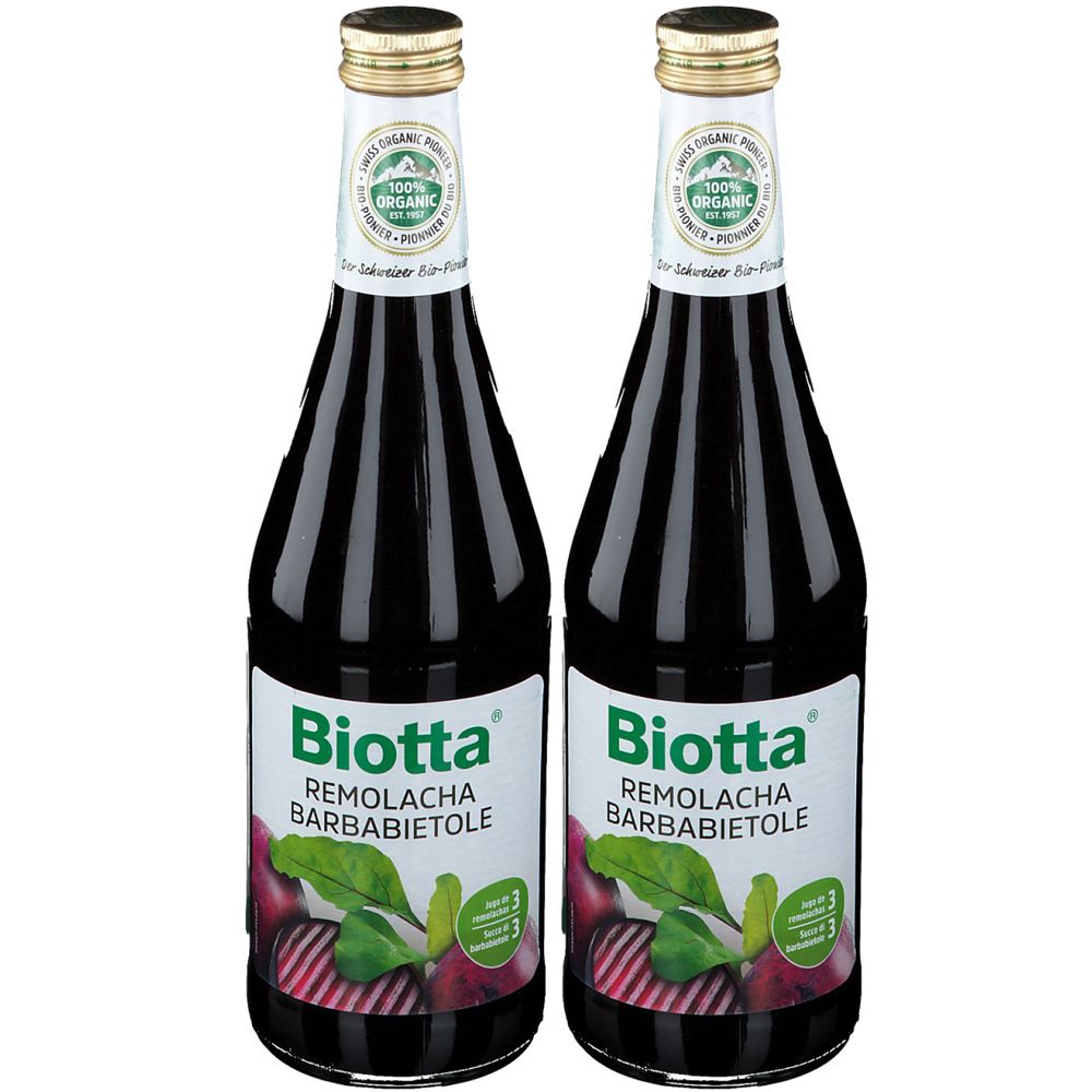 Due bottiglie di succo rosso scuro. Etichette con "Biotta Remolacha Barbabietole". In alto, sigillo "100% Organic".