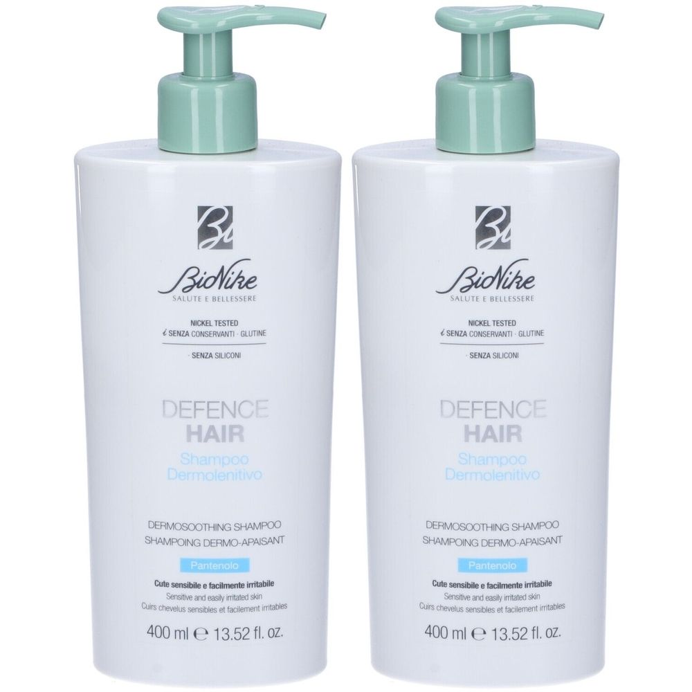 Due flaconi bianchi con erogatori verdi. Scritta: BioNike Defence Hair Shampoo. Testo in italiano e inglese.