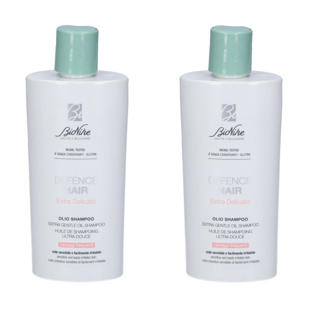 Due flaconi bianchi con tappi verdi. Scritta: BioNike Defence Hair Extra Delicato Olio Shampoo.