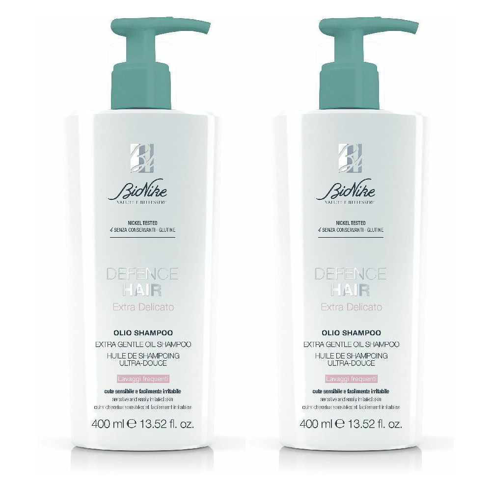 Due flaconi bianchi con erogatori turchese. Su ogni flacone, si legge "DEFENCE HAIR" e "OLIO SHAMPOO".