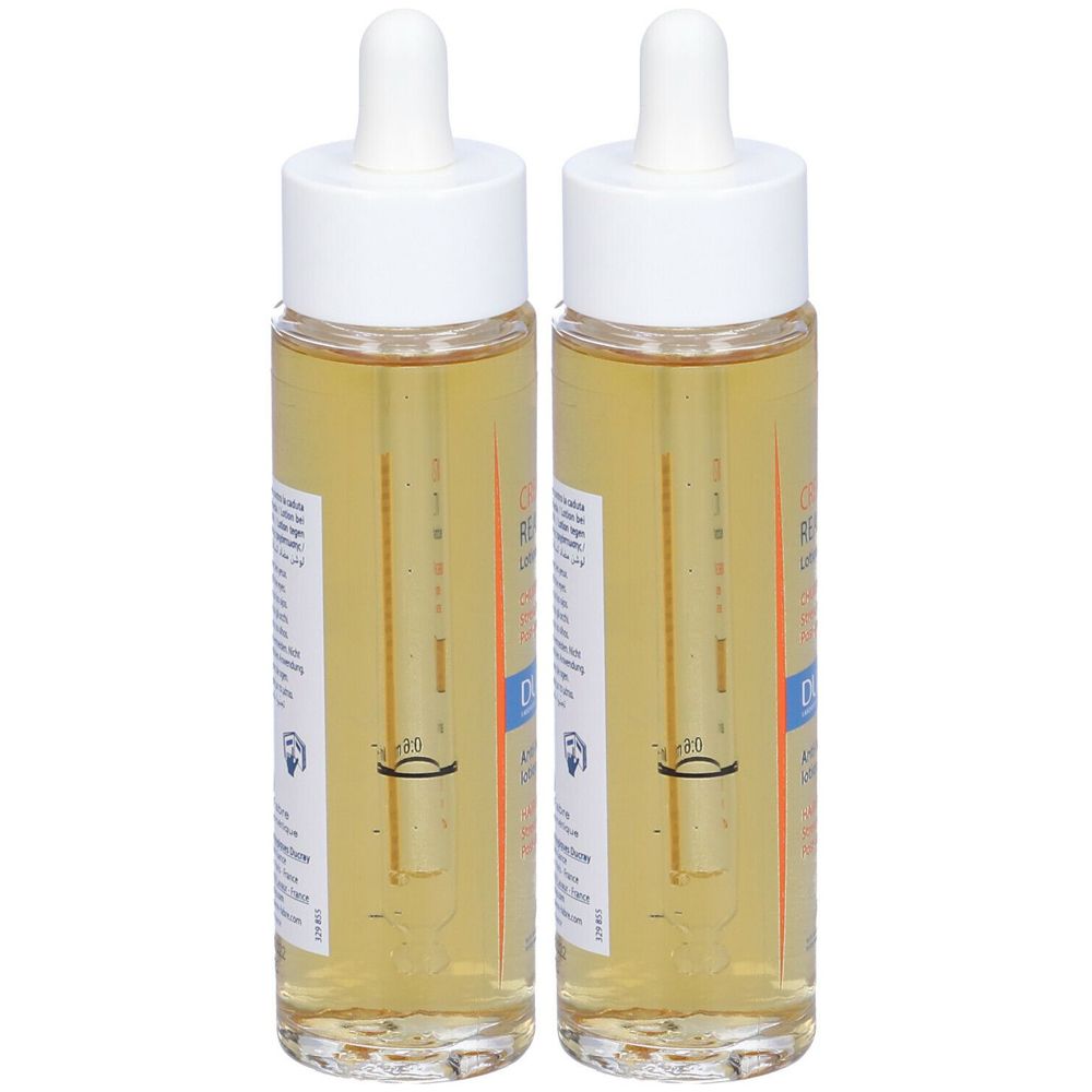 Due flaconi con liquido giallo e tappi bianchi. Etichette con testo sui flaconi. Pipette di vetro sporgono.