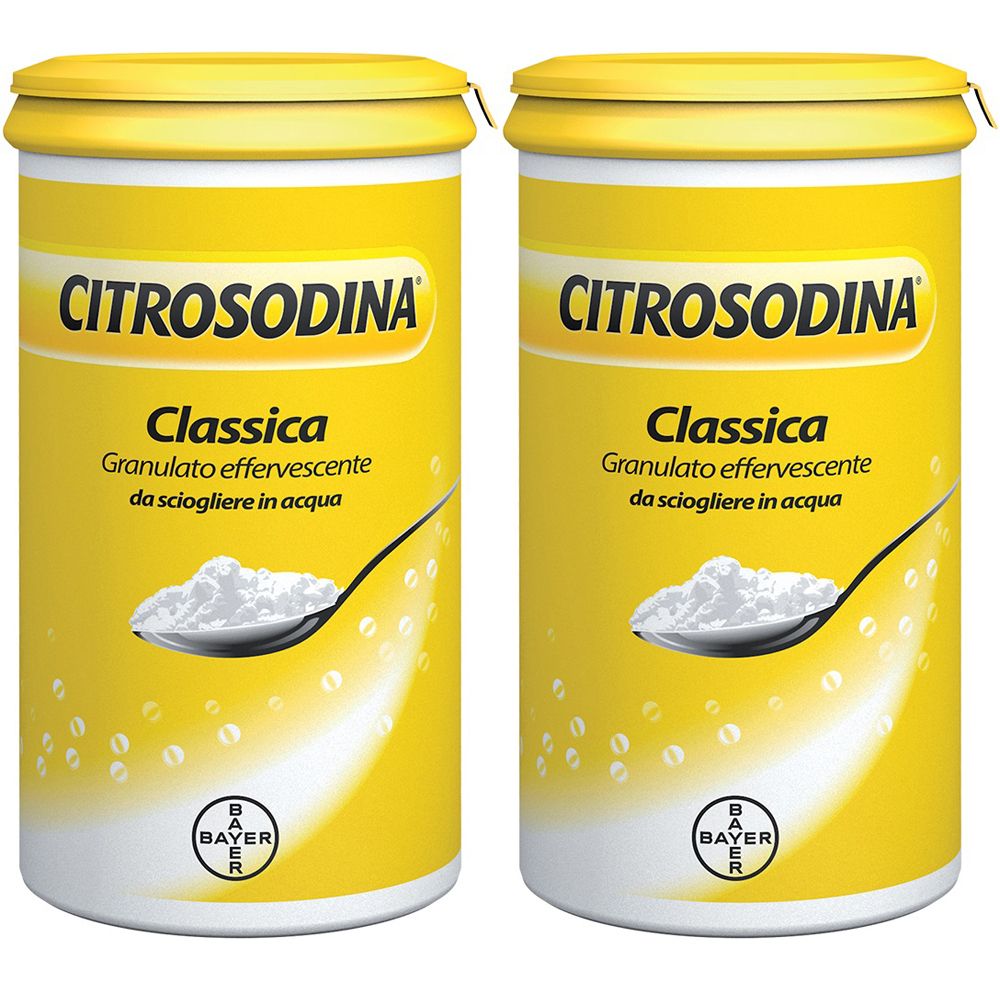 Due barattoli gialli di Citrosodina Classica Granulato Effervescente. Scritta e cucchiaio con granulato.