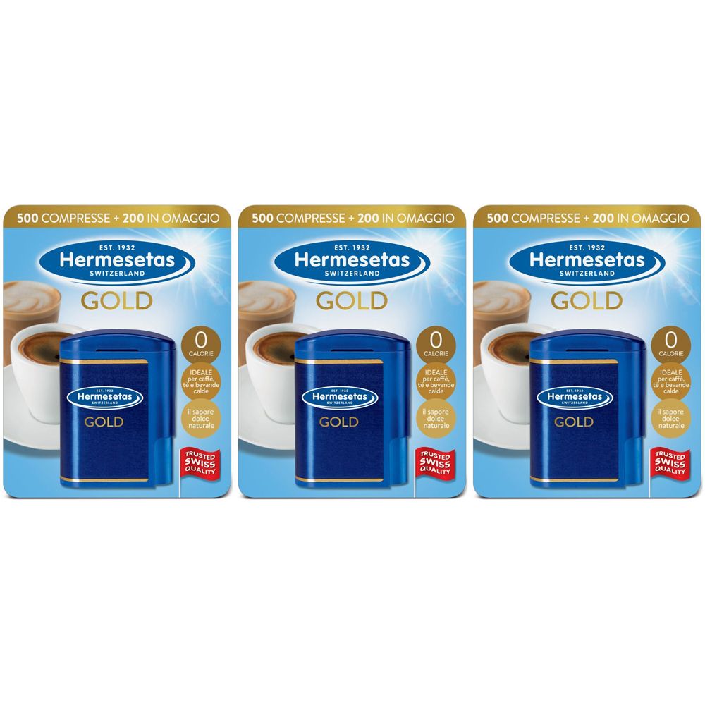 Tre confezioni di Hermesetas Gold. Ogni confezione contiene una scatola blu e una scheda con testo. Sulla scatola c'è scritto "GOLD".