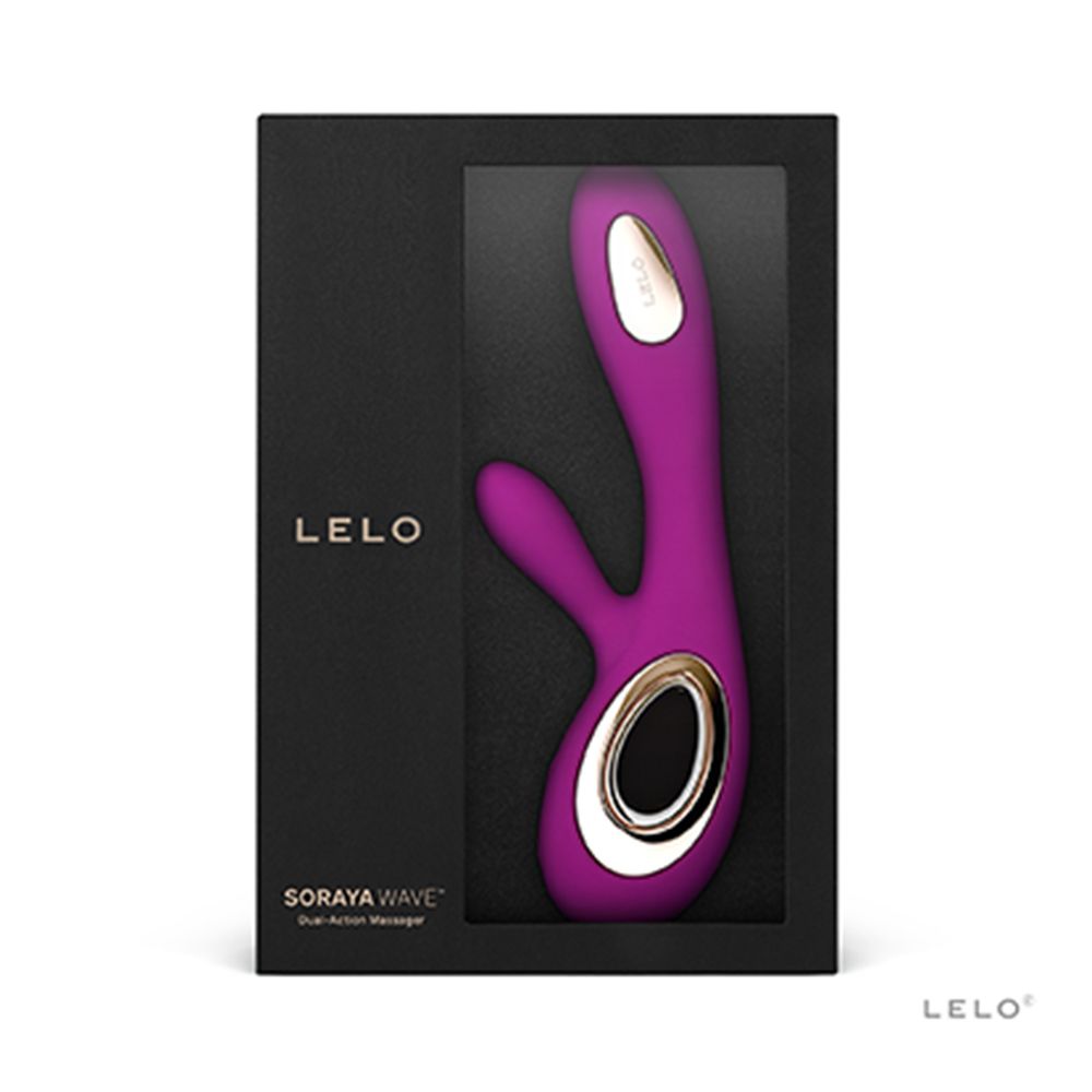 Schwarze Verpackung mit Fenster. Lila Vibrator mit goldfarbenen Akzenten sichtbar.