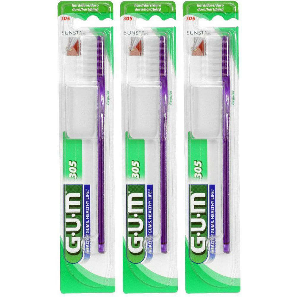 Tre spazzolini confezionati. Manico viola, setole bianche. Marchio G.U.M, modello 305. Confezione verde e trasparente.
