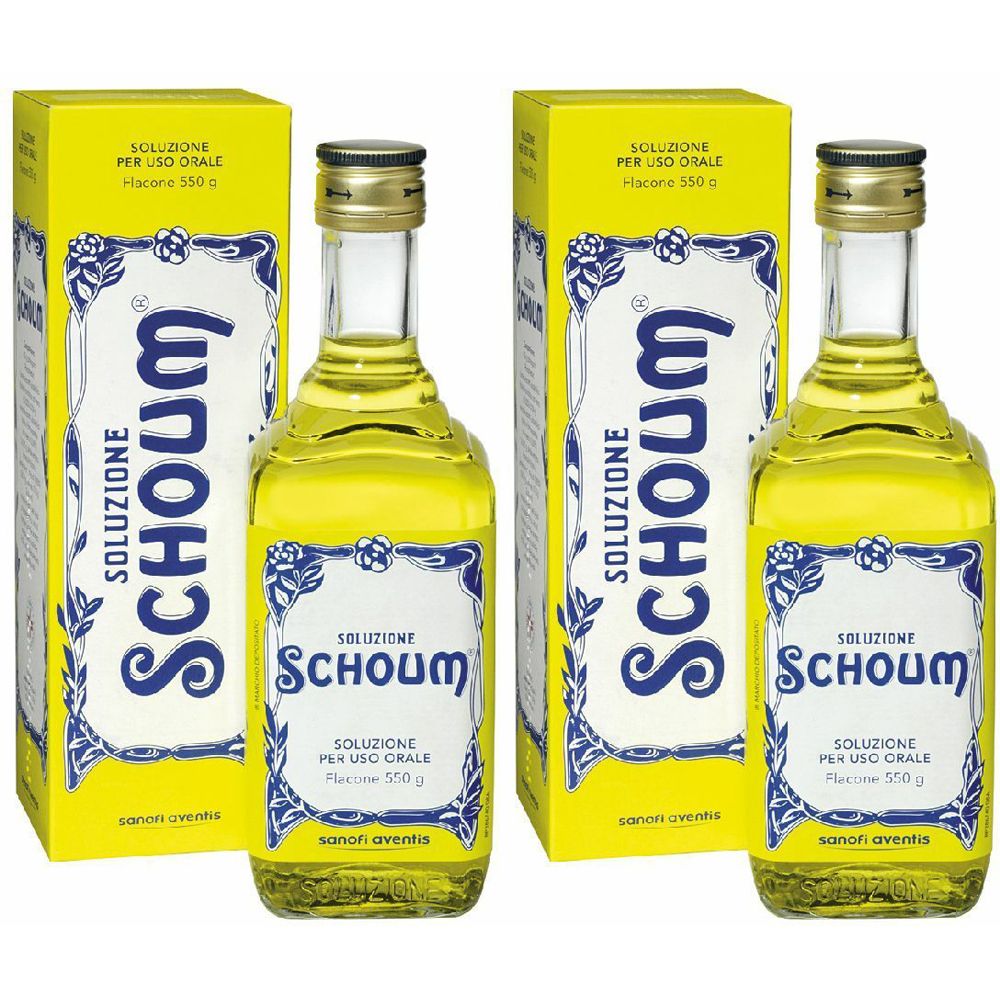 Due bottiglie e confezioni. Liquido giallo in bottiglie di vetro con tappi dorati. Scritta: Schoum, Soluzione.