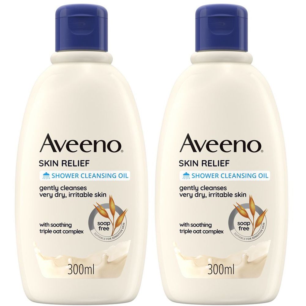 Due flaconi di olio detergente doccia Aveeno Skin Relief. Flaconi bianchi con tappo blu. Testo: Skin Relief, Shower Cleansing Oil, 300ml.