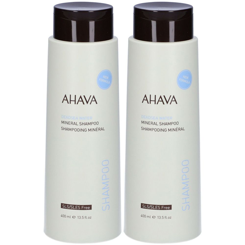 Due flaconi di shampoo minerale AHAVA. Flaconi verde chiaro con tappi marroni. Scritta: AHAVA, Mineral Shampoo, Shampooing Mineral. Senza SLS/SLES.