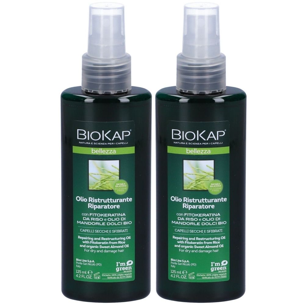 Due flaconi verdi con vaporizzatore. Scritta: BIOKAP, Olio Ristrutturante Riparatore. Per capelli secchi e danneggiati.