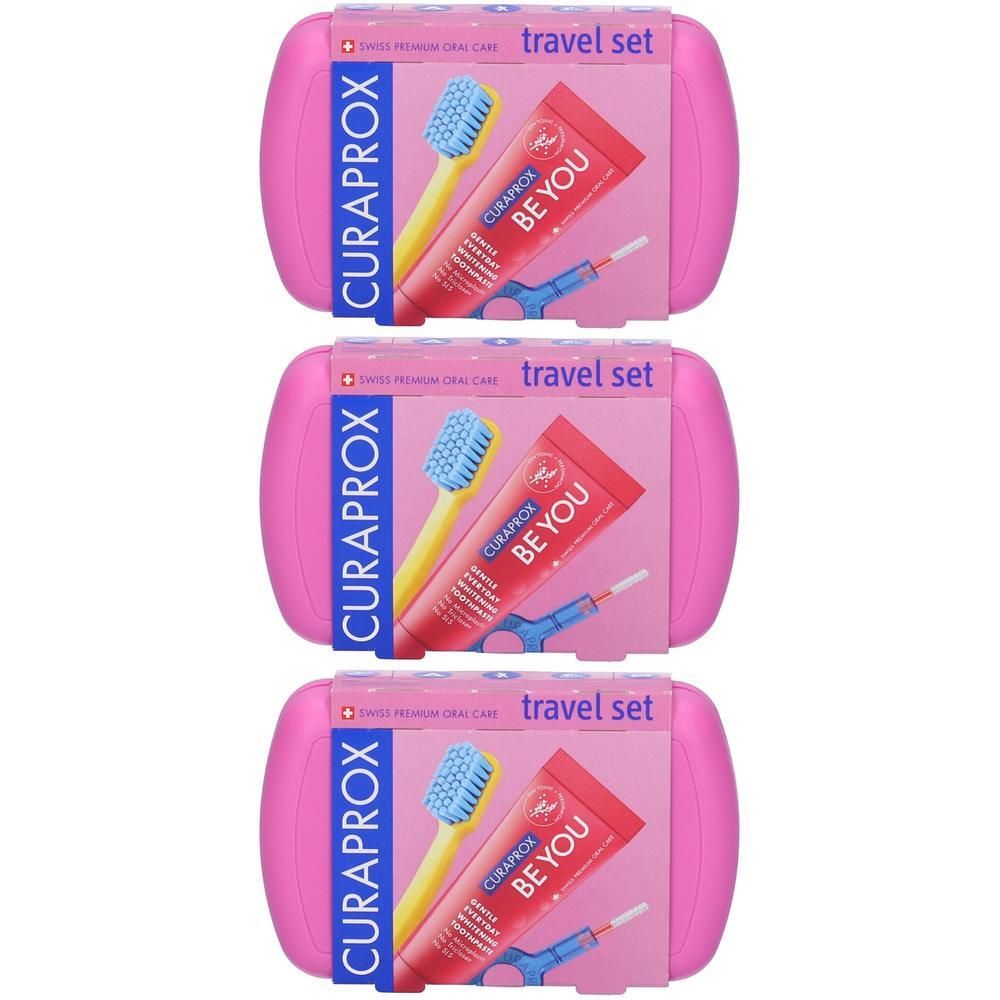 Set da viaggio Curaprox con spazzolino, dentifricio e scovolini interdentali in astuccio rosa.