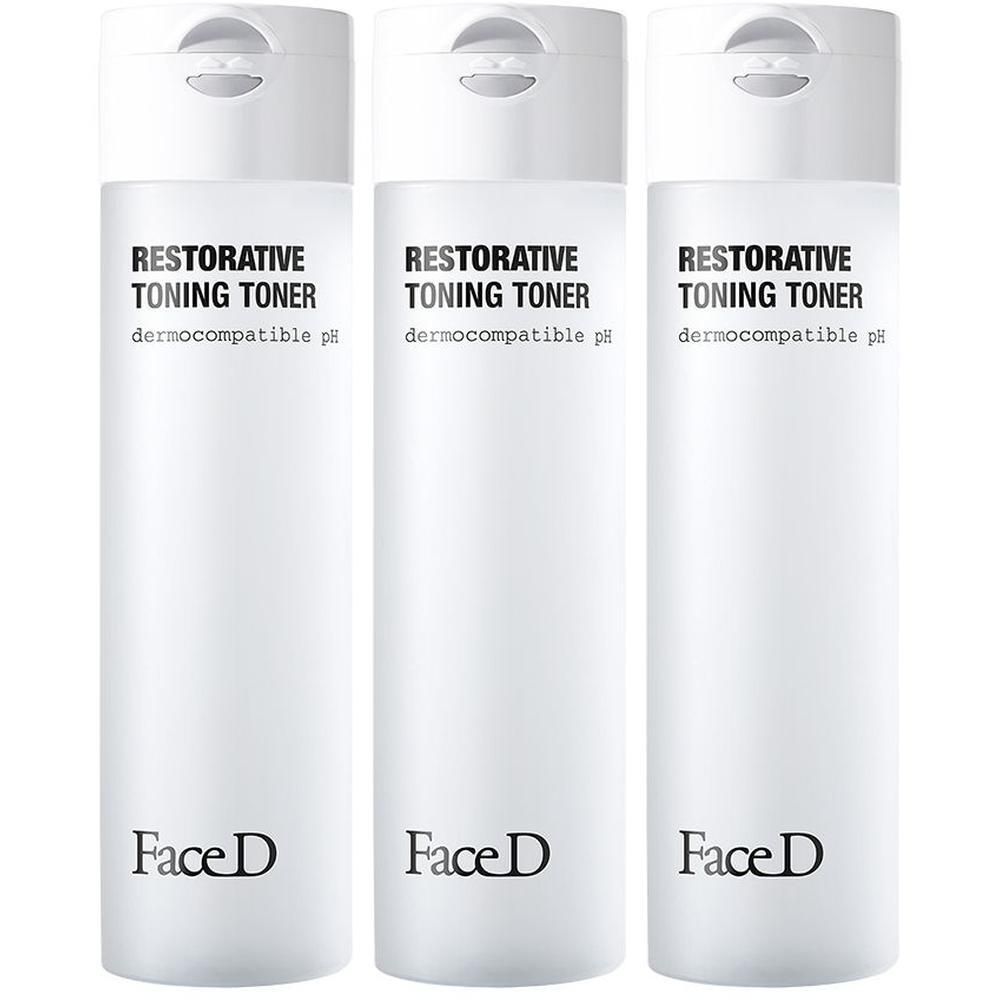 Tre flaconi di Face D Restorative Toning Toner con tappo bianco ed etichetta.