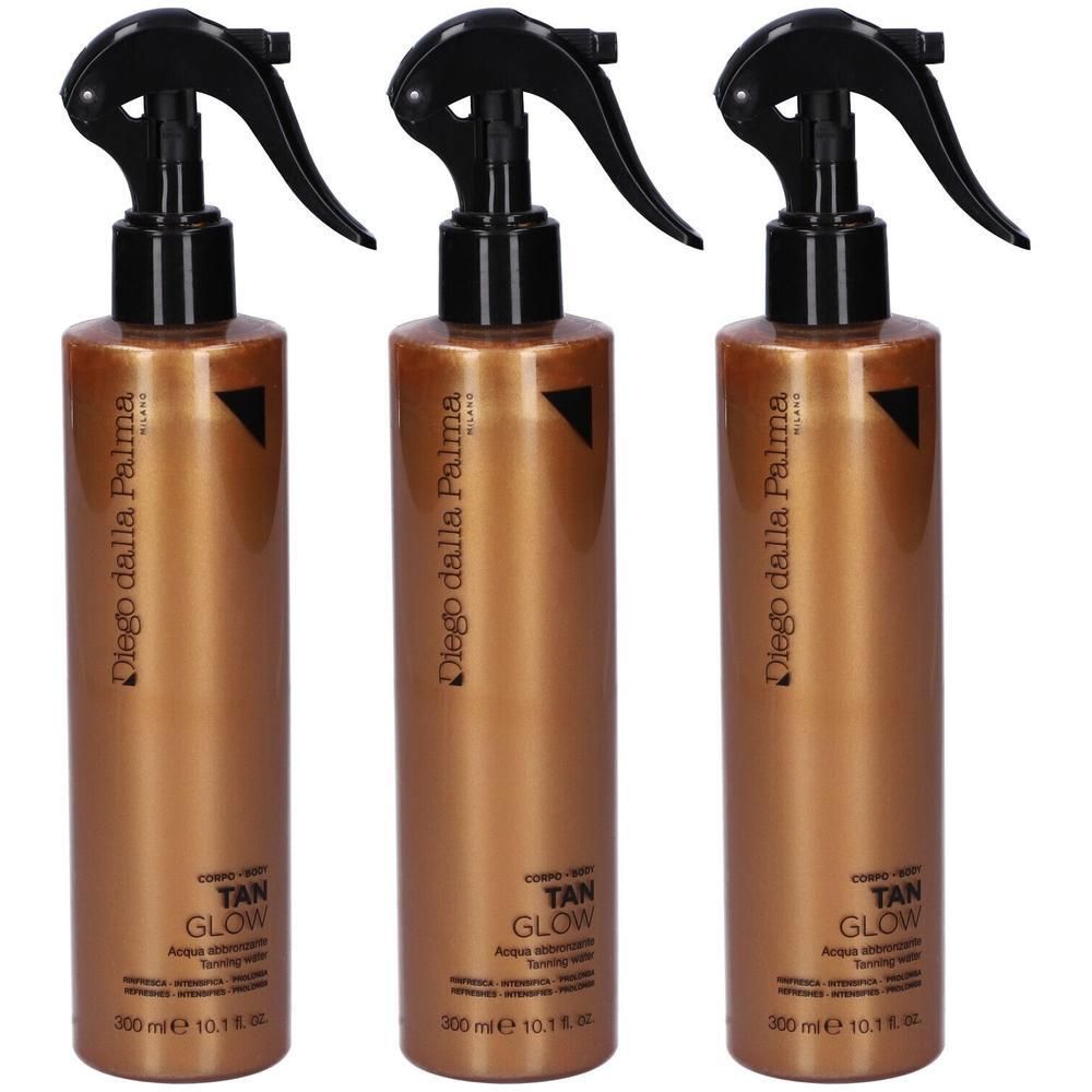 Tre flaconi spray color bronzo con erogatore nero. Etichetta: TAN GLOW.