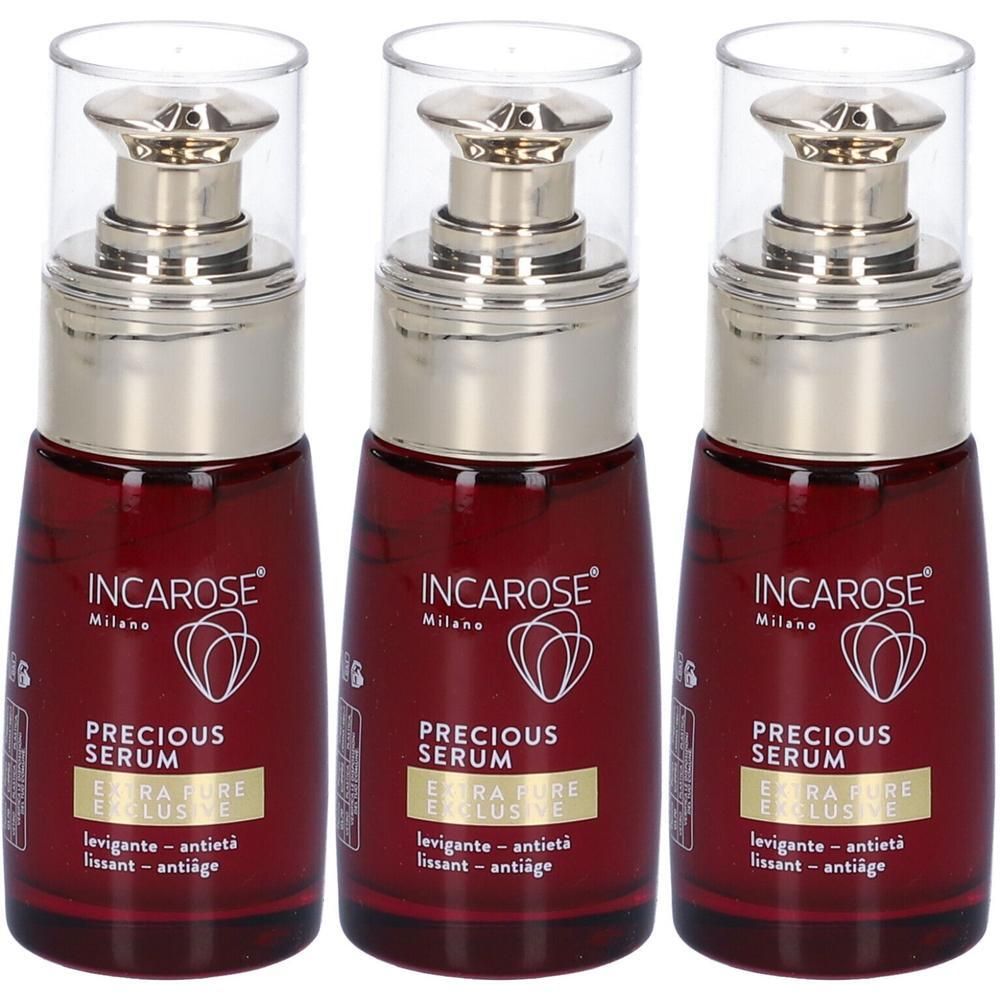 Tre flaconi di Incarose Precious Serum con dosatori a pompa. Flaconi in vetro rosso scuro con accenti argentati e tappi trasparenti.