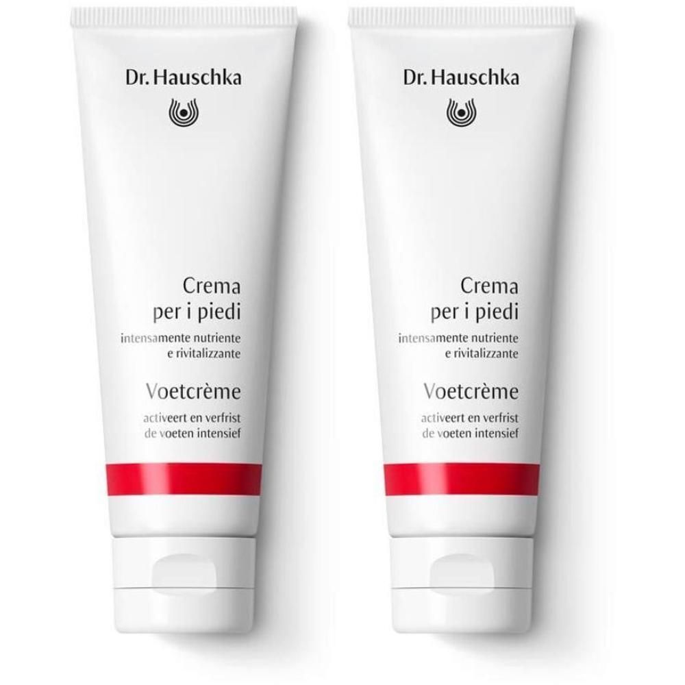 Due tubetti bianchi di Crema per i piedi Dr. Hauschka con banda rossa in basso.
