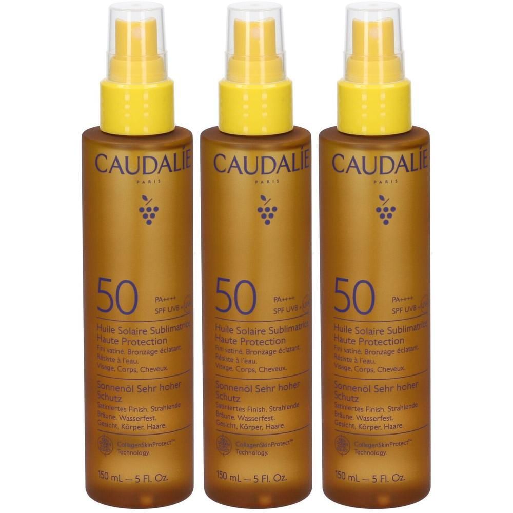 Tre flaconi spray color oro di Caudalie, olio solare SPF 50.