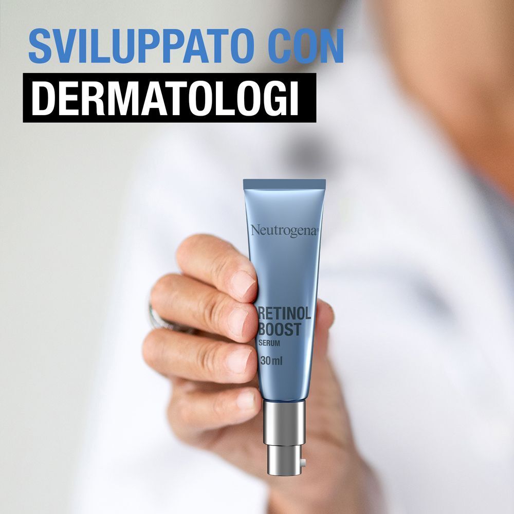 Mano che tiene un flacone di siero Neutrogena Retinol Boost da 30ml con dispenser.