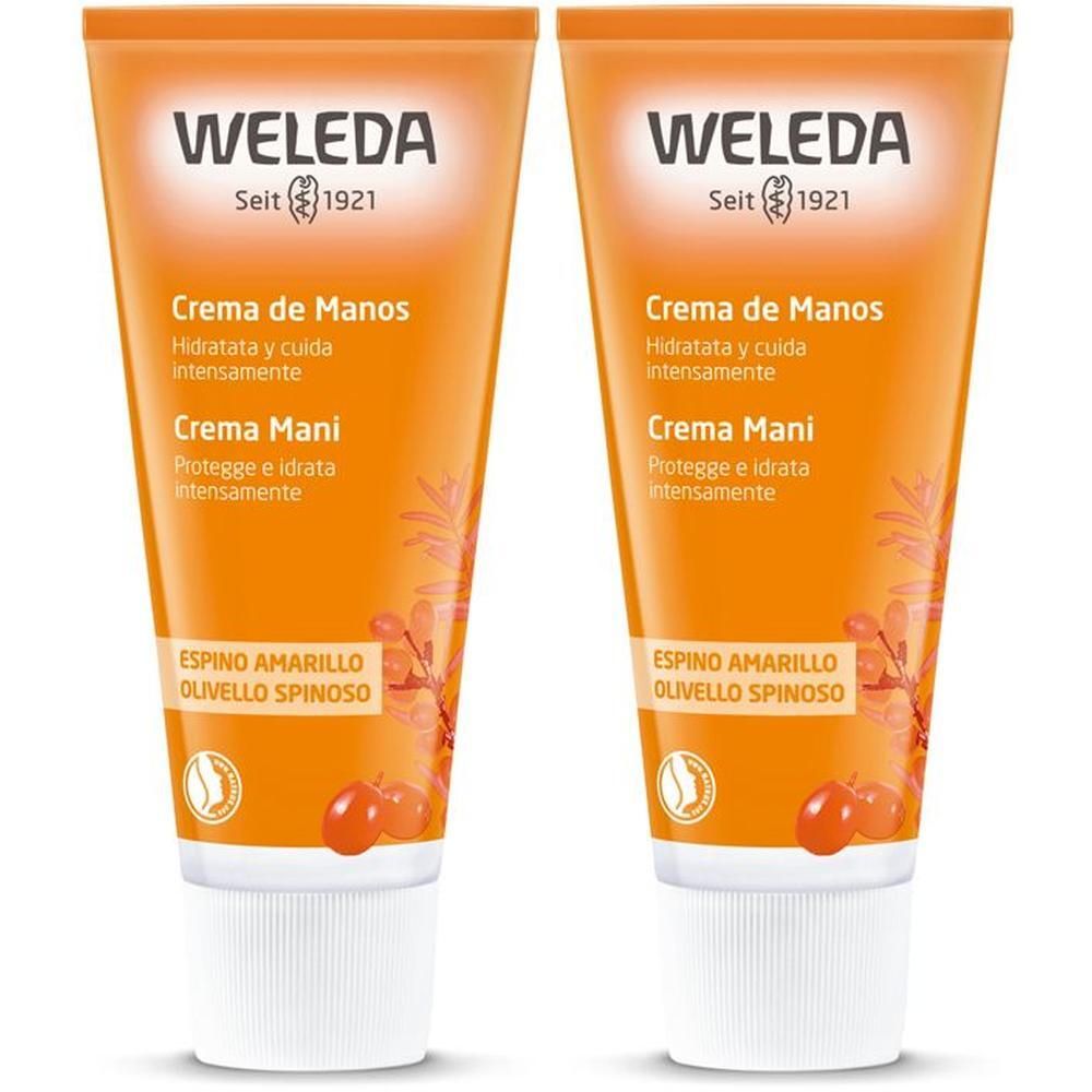 Due tubi di crema mani all'olivello spinoso, arancioni con tappi bianchi. Logo Weleda in alto.
