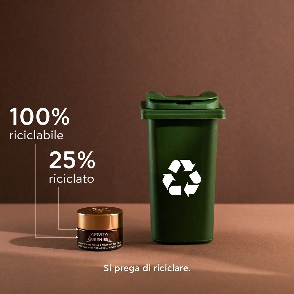 Vasetto crema contorno occhi APIVITA Queen Bee accanto a un bidone di riciclaggio verde. 100% riciclabile.