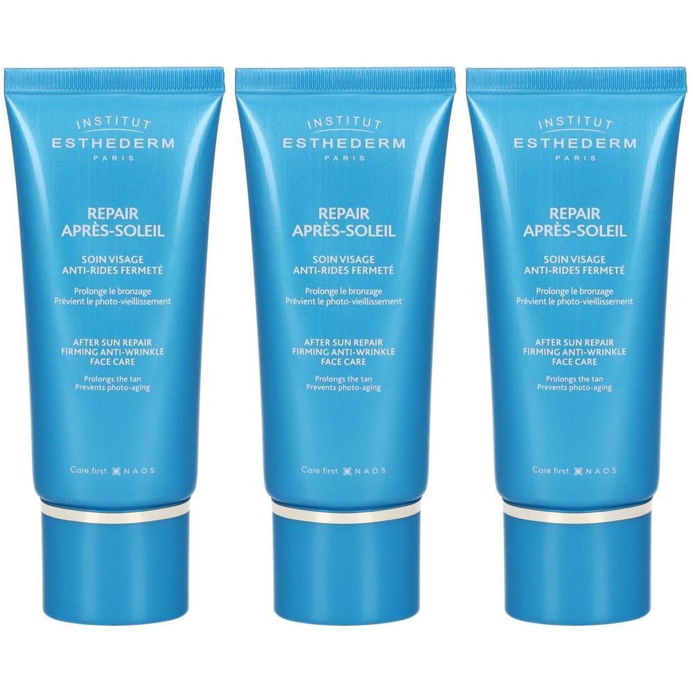 Tre tubetti di crema riparatrice doposole Institut Esthederm. Tubetti blu con scritte bianche e argentate.