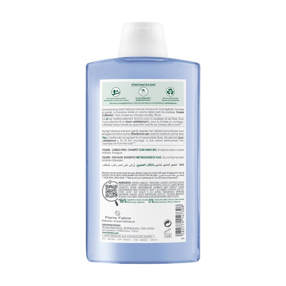 Retro di una bottiglia di shampoo blu con etichetta che elenca ingredienti e certificazioni.