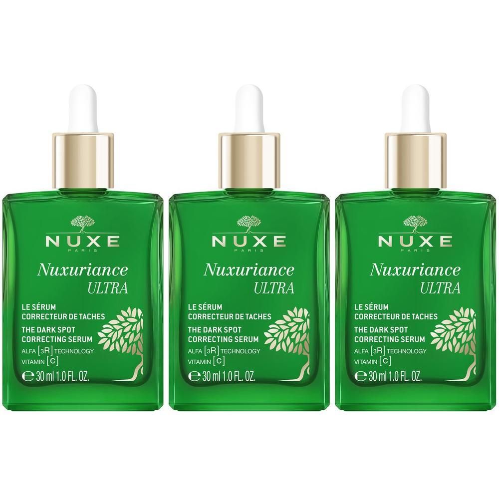Tre flaconi in vetro verde Nuxe Nuxuriance Ultra Siero con contagocce.