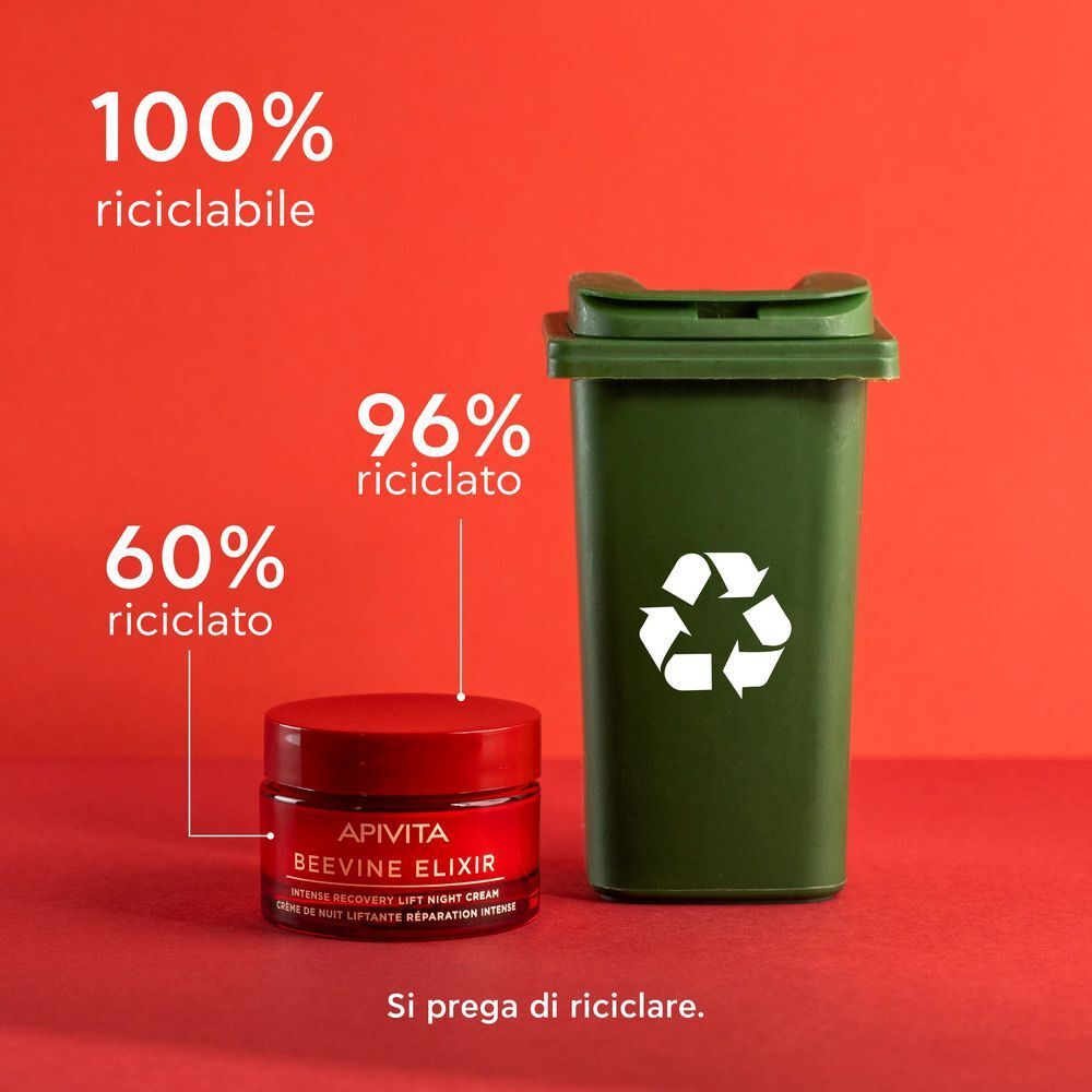 Vasetto rosso APIVITA BEEVINE ELIXIR crema notte accanto a un bidone verde.