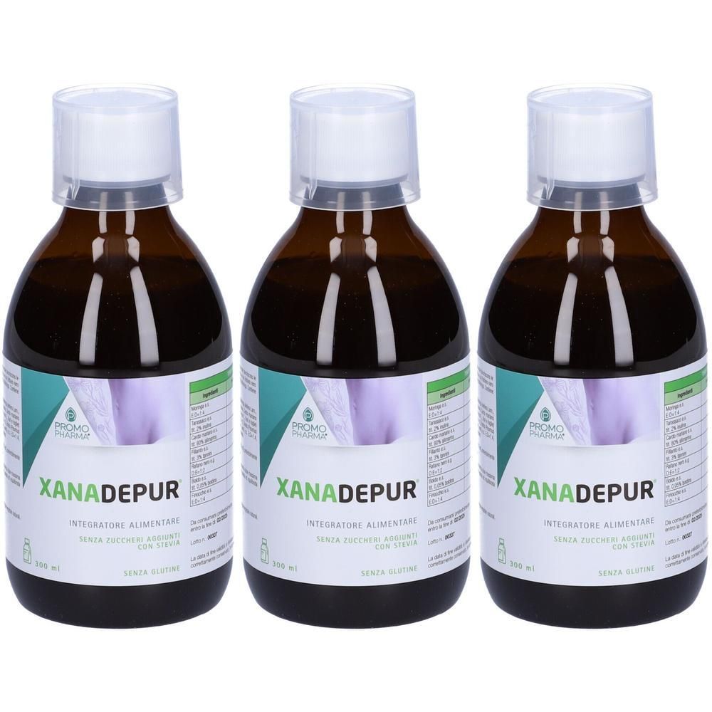 Tre flaconi in vetro ambrato con tappo a vite bianco, contenenti liquido scuro. Etichette con scritta "XANADEPUR".