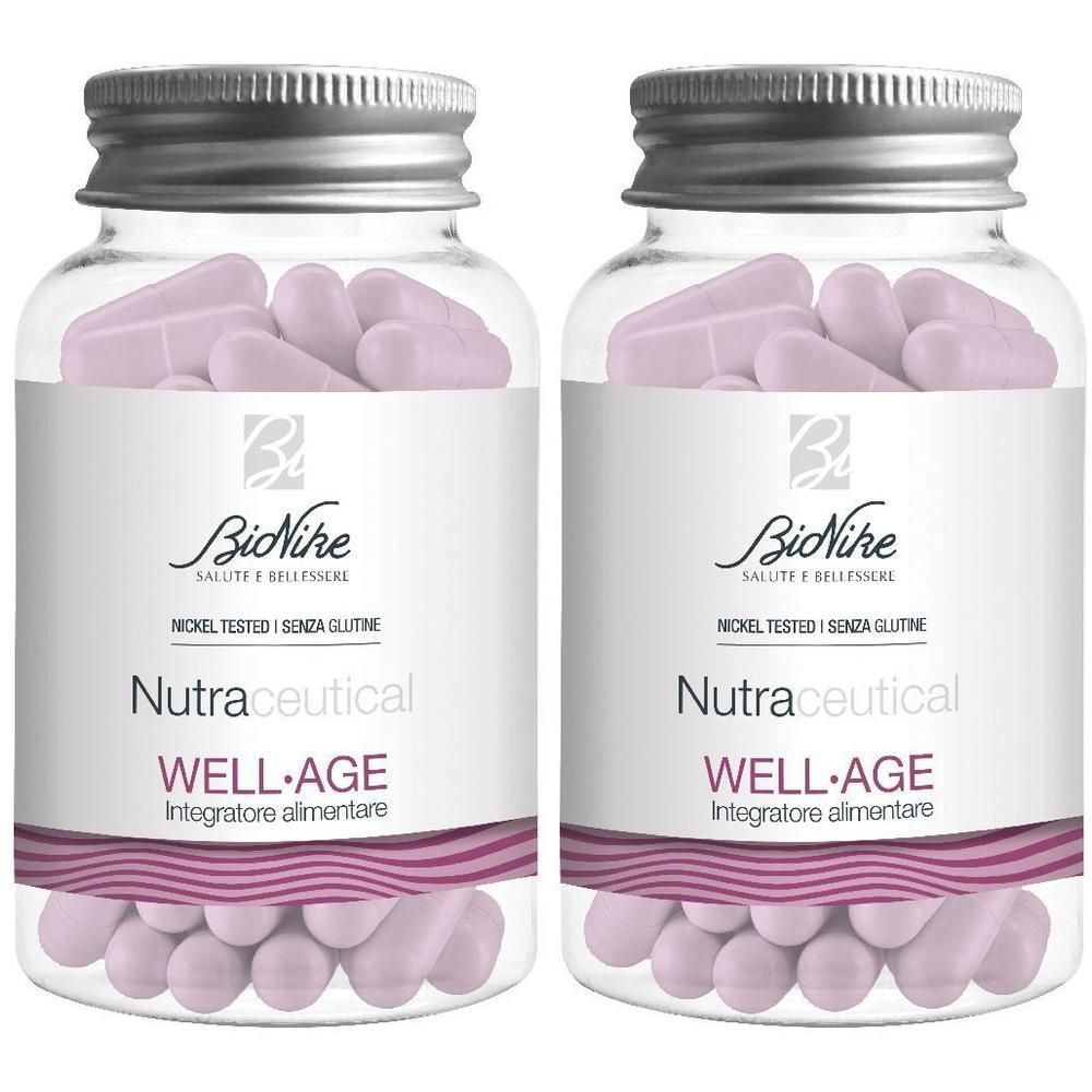 Due flaconi di capsule BioNike Well-Age. Contenitori trasparenti con tappi argentati, contenenti capsule color lilla.