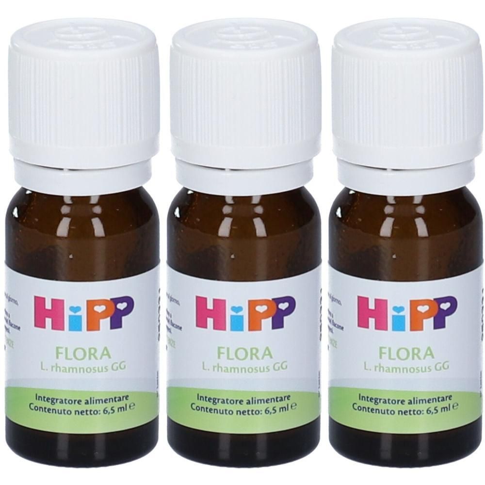 Tre piccole bottiglie di vetro marrone con tappi a vite bianchi, etichettate Hipp Flora L. rhamnosus GG.