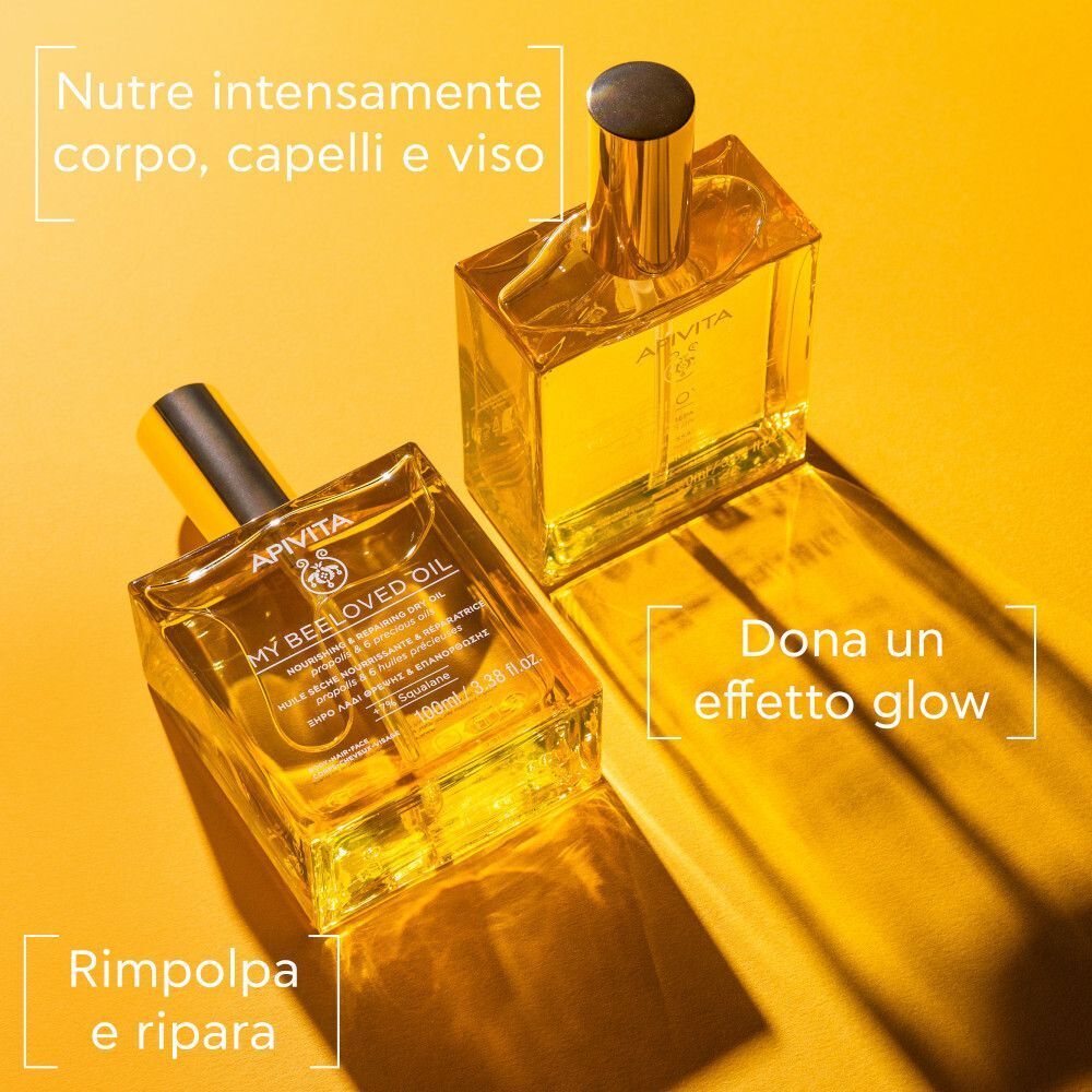 Due flaconi di APIVITA My Beeloved Oil su sfondo giallo. Testo: 'Nutre intensamente corpo, capelli e viso', 'Dona un effetto glow', 'Rimp পলpa e ripara'.