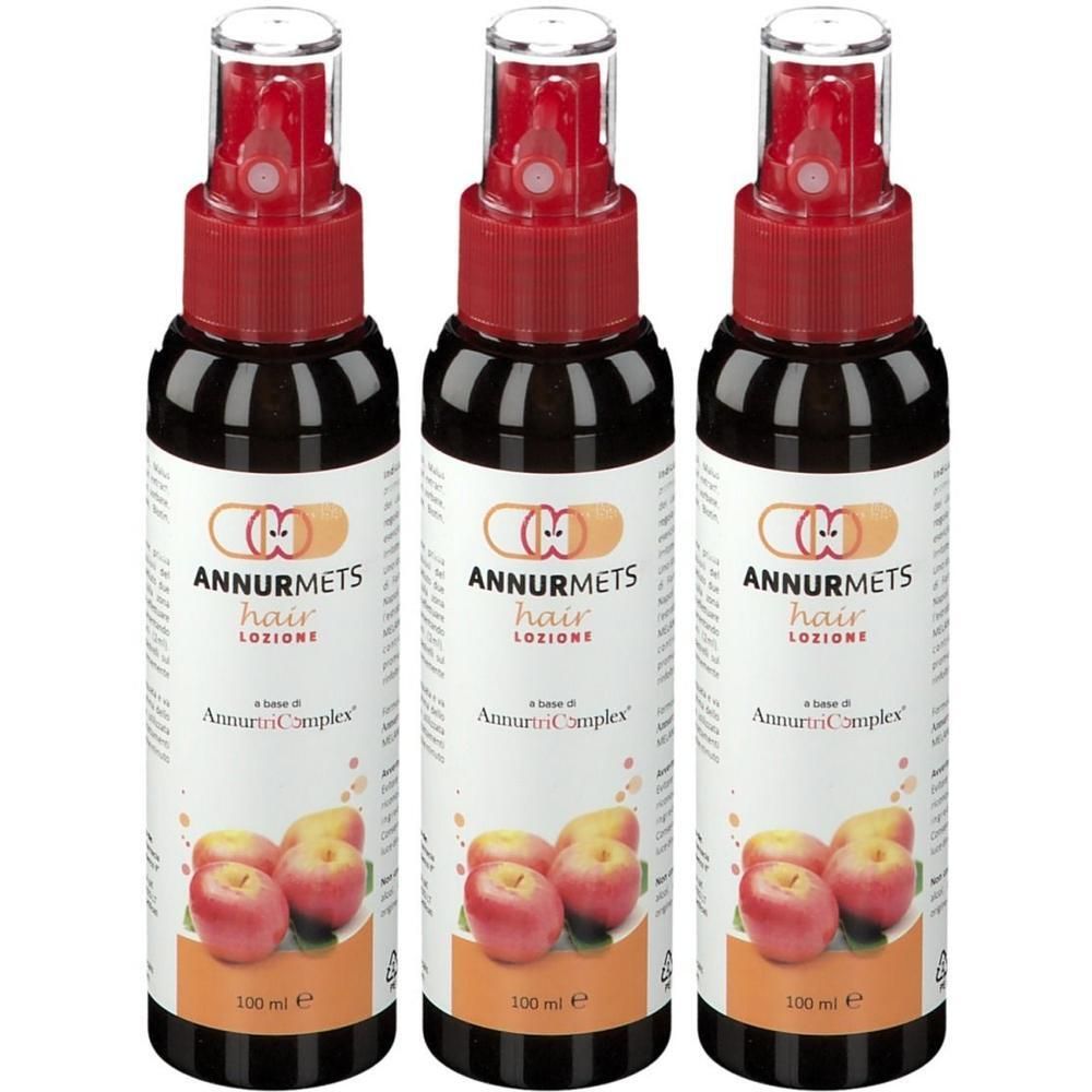 Tre flaconi di lozione per capelli Annurmets con spruzzatore rosso ed etichetta con mele.