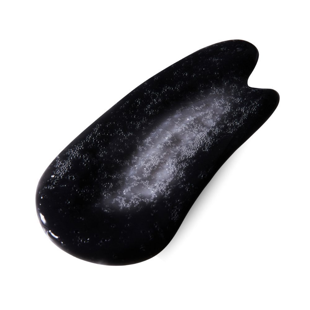 Maschera viso nera all'ossigeno e detox, con particelle visibili.