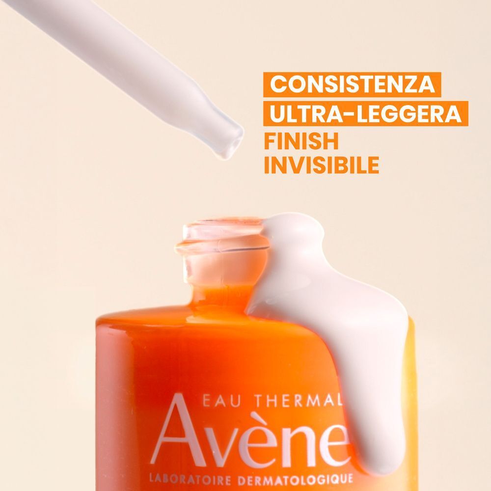 Primo piano del collo del flacone Eau Thermale Avène Ultra Siero SPF50+, siero che cola dalla pipetta. Testo: 'Consistenza ultra-leggera Finish invisibile'.