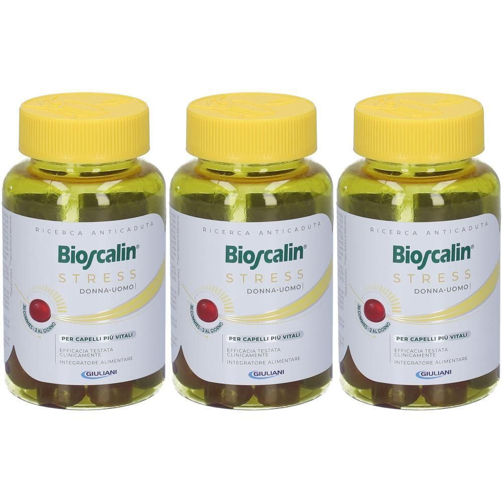 Tre flaconi di integratori Bioscalin Stress con tappi gialli.
