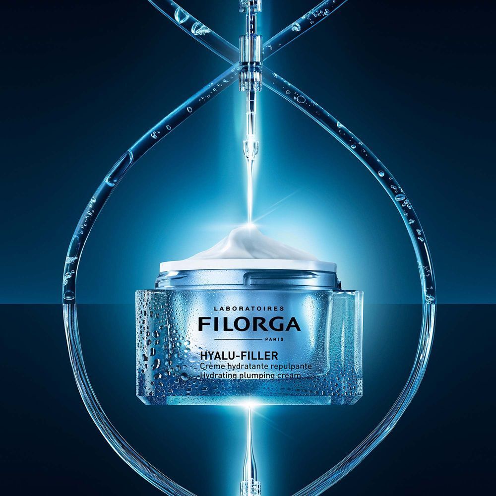 Vasetto Filorga Hyalu-Filler con gocce e pipetta sotto luce blu.