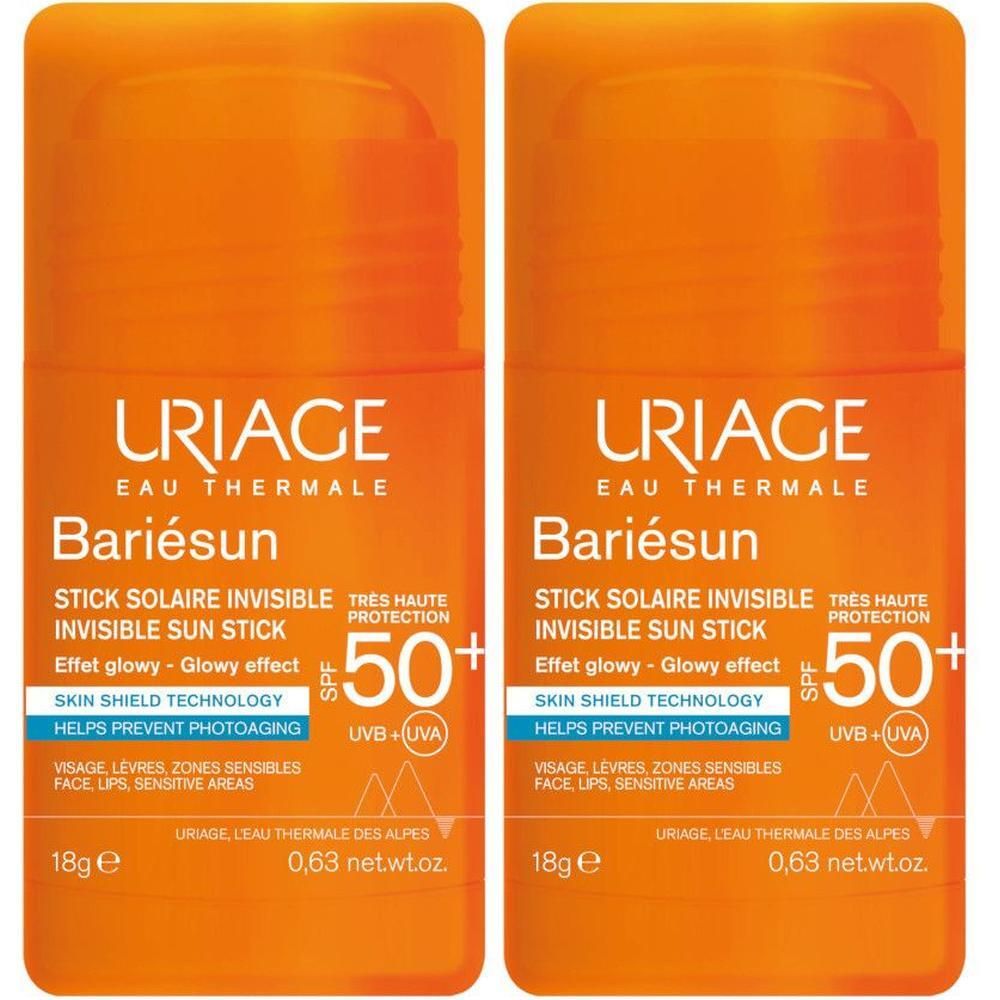 Due stick solari invisibili URIAGE BARIESUN SPF50+ con corpo arancione e tappo bianco.