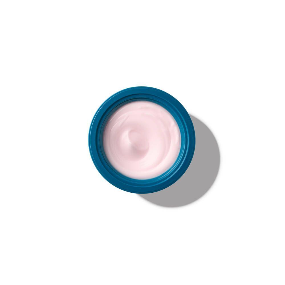 Un vasetto blu con crema rosa, visto dall'alto.