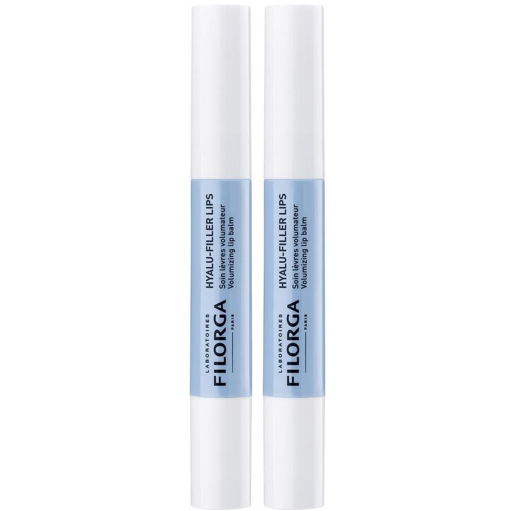 Due penne bianche con fascia blu e applicatore nero per balsamo labbra.